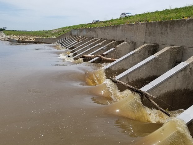 Photo of  water being released during flooding from a dam.